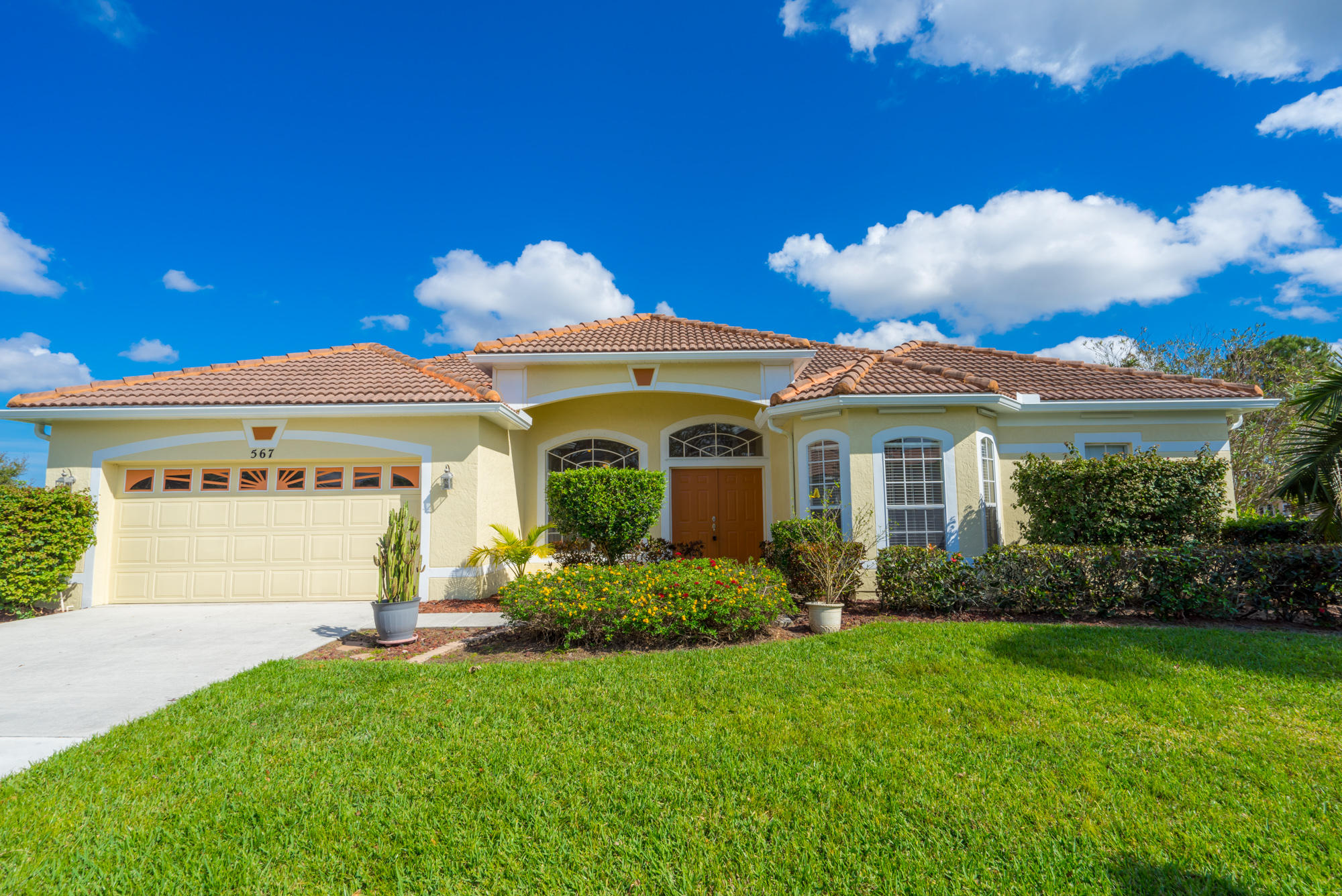 567 Southwest Spring Hill Point Port St. Lucie, FL 34986 - Photo 35 of 36 a front view of a house with garden