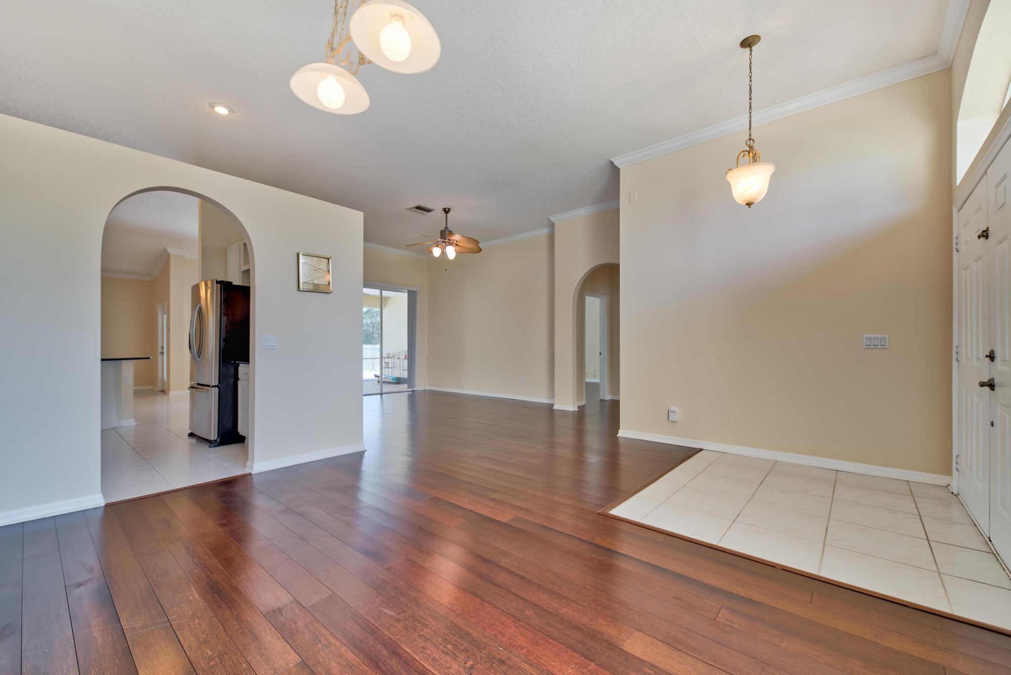 567 Southwest Spring Hill Point Port St. Lucie, FL 34986 - Photo 4 of 36 wooden floor in an empty room with a window