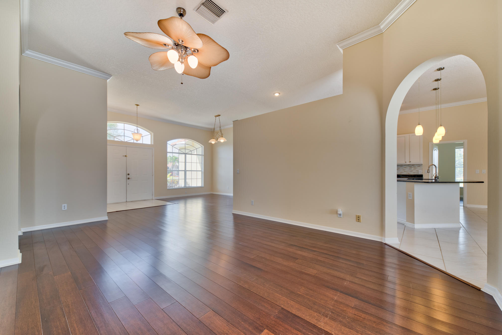 567 Southwest Spring Hill Point Port St. Lucie, FL 34986 - Photo 5 of 36 a view of an empty room with a window and wooden floor