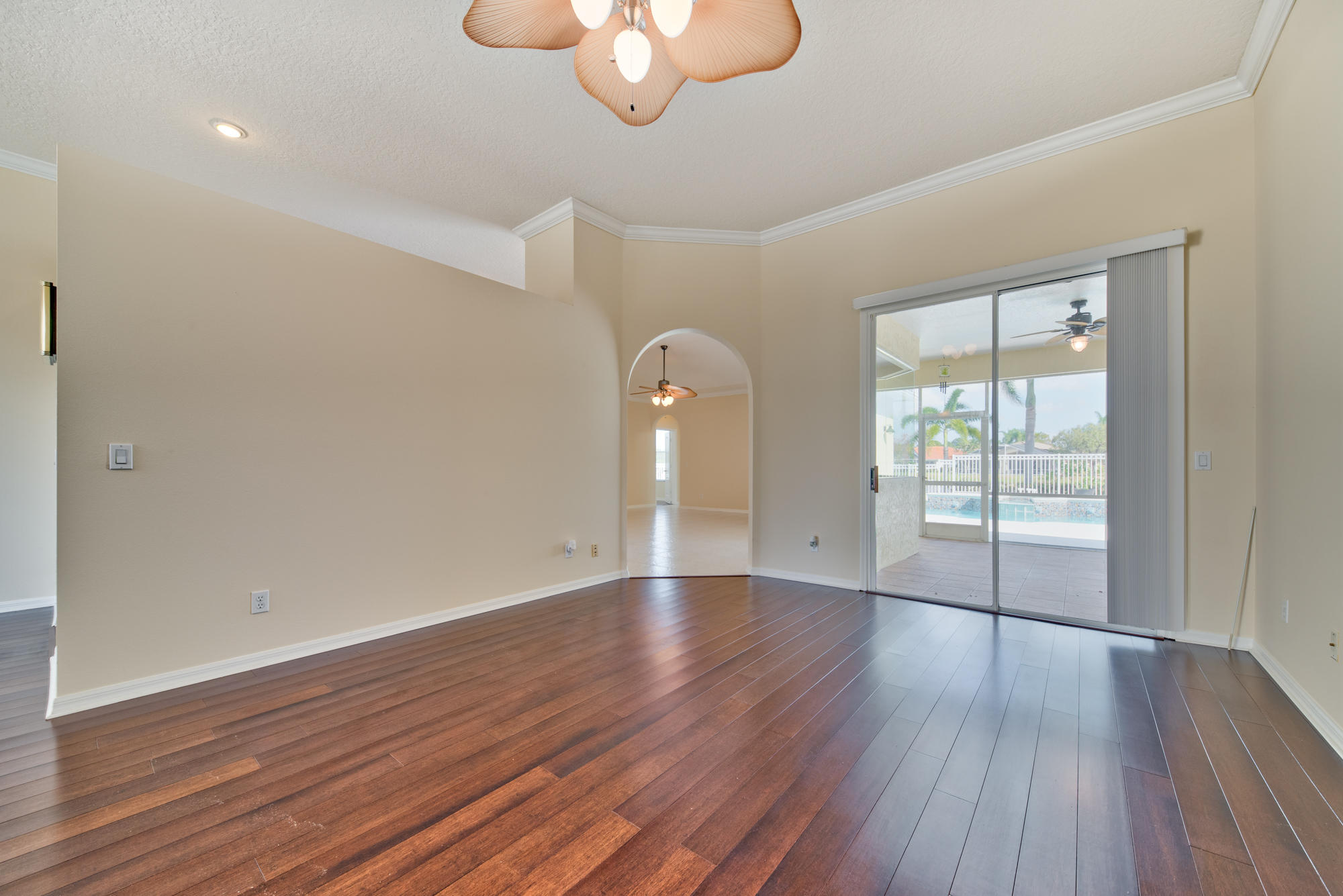 567 Southwest Spring Hill Point Port St. Lucie, FL 34986 - Photo 6 of 36 a view of an empty room with wooden floor and a window