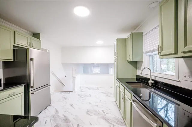 a kitchen with a sink stove and refrigerator