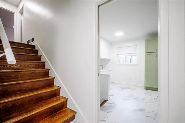 a view of entryway and hall with wooden floor