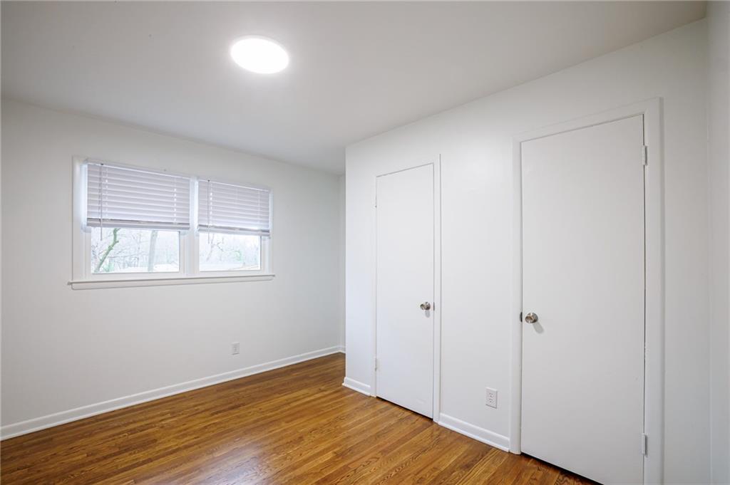 2692 Whites Mill Court Decatur, GA 30034 - Photo 23 of 33 a view of an empty room with wooden floor and a window