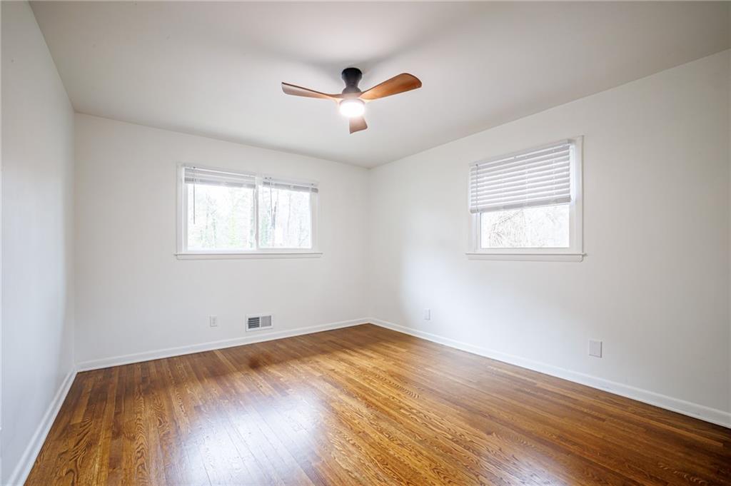 2692 Whites Mill Court Decatur, GA 30034 - Photo 26 of 33 a view of an empty room with wooden floor and a window