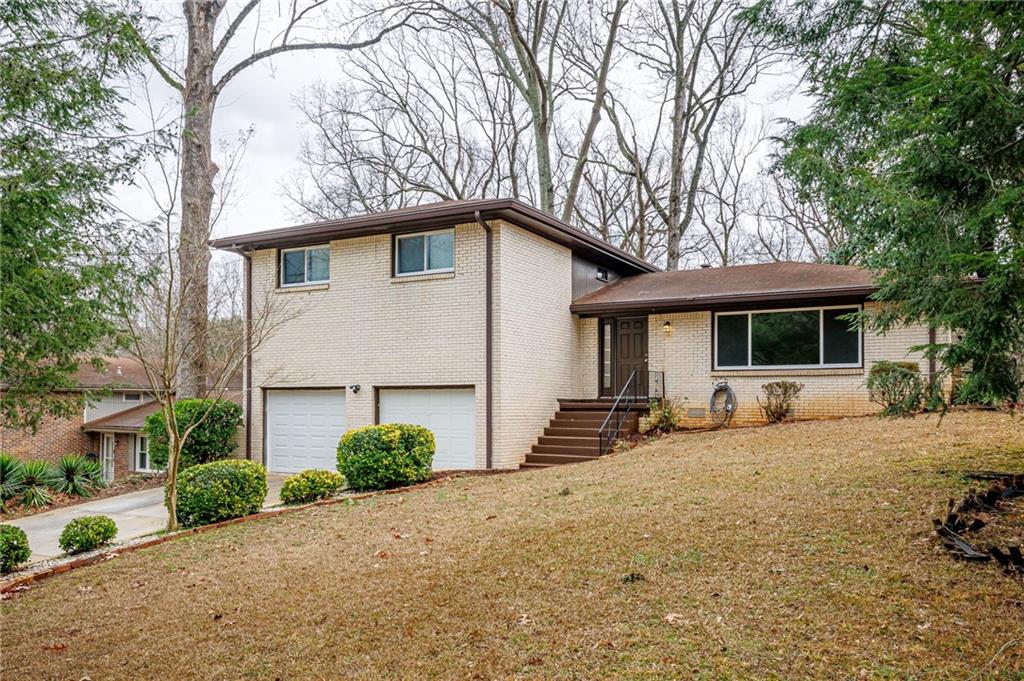 2692 Whites Mill Court Decatur, GA 30034 - Photo 3 of 33 a front view of a house with a yard and garage