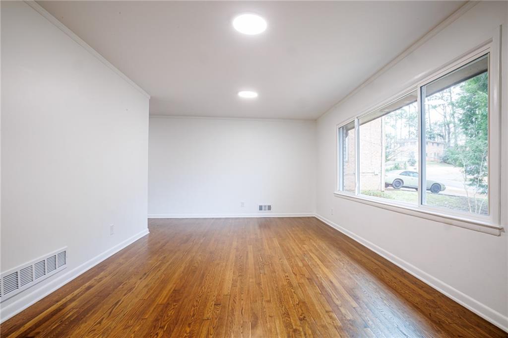 2692 Whites Mill Court Decatur, GA 30034 - Photo 6 of 33 an empty room with wooden floor and windows