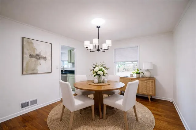 a dining room with furniture and chandelier