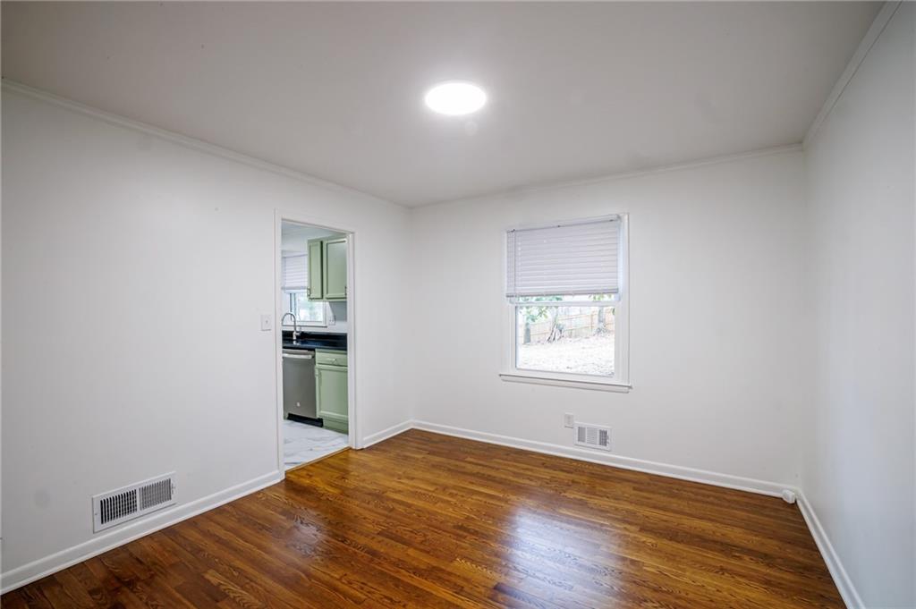 2692 Whites Mill Court Decatur, GA 30034 - Photo 9 of 33 an empty room with wooden floor and windows