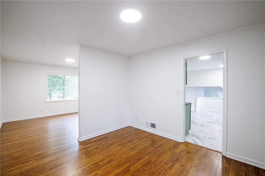 2692 Whites Mill Court Decatur, GA 30034 - Photo 10 of 33 an empty room with wooden floor and windows