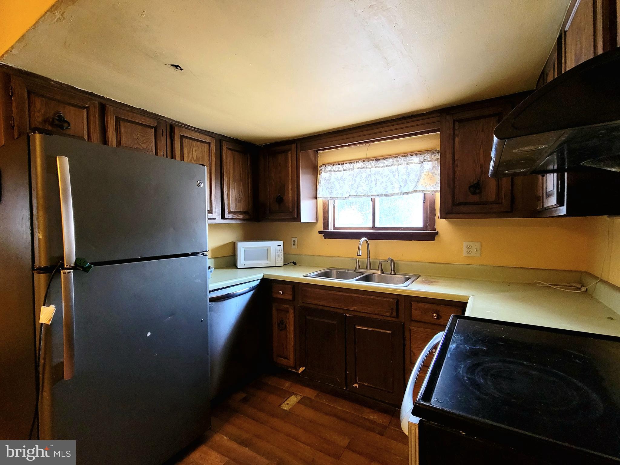 357 Spring Street Houtzdale, PA 16651 - Photo 11 of 19 a kitchen with a sink a refrigerator and cabinets