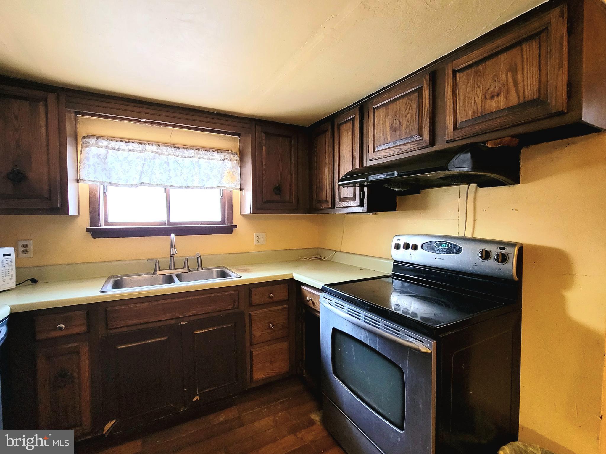 357 Spring Street Houtzdale, PA 16651 - Photo 12 of 19 a kitchen with a sink a stove cabinets and a window