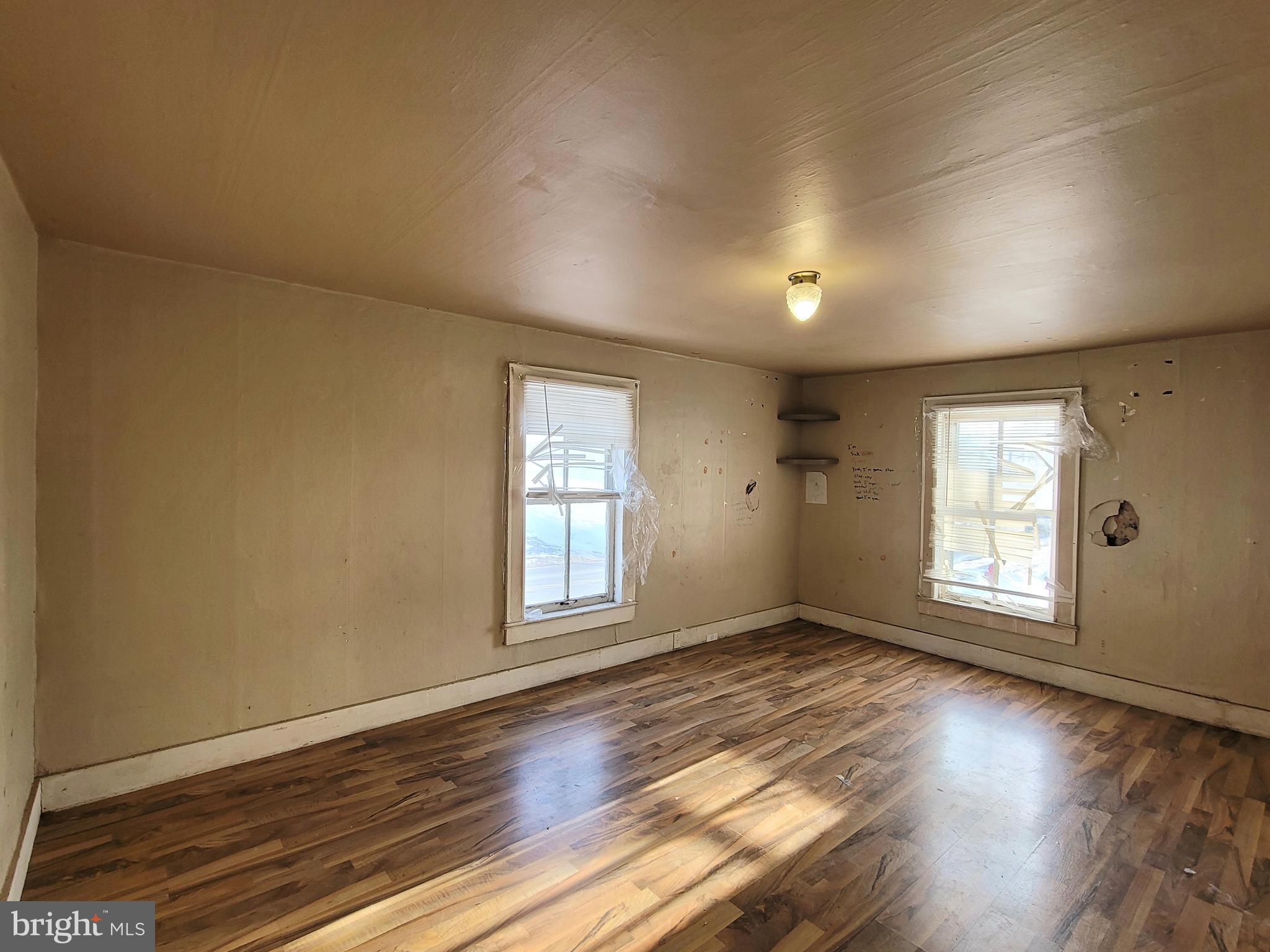 357 Spring Street Houtzdale, PA 16651 - Photo 18 of 19 an empty room with wooden floor and windows