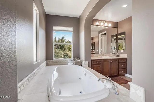 a spacious bathroom with a bathtub and a sink