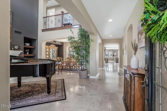 a lobby with furniture and a potted plant