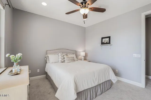a bedroom with a bed and ceiling fan