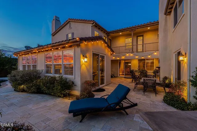 a view of a dinning tables and chairs in a patio