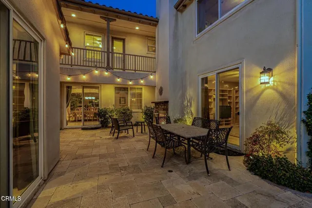 a view of a patio with couches table and chairs and potted plants