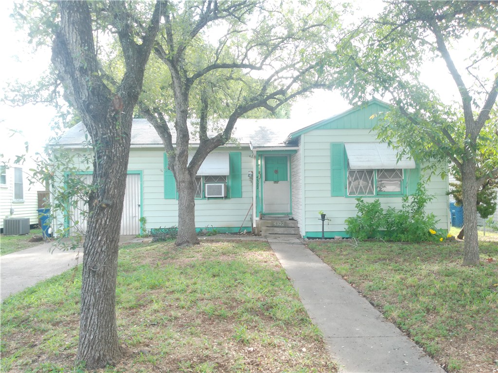 4322 Fir Street Corpus Christi, TX 78411 - Photo 2 of 17 a front view of a house with a garden and trees