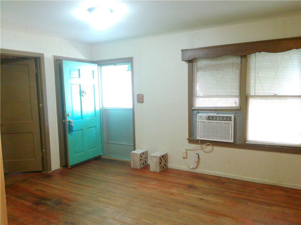 4322 Fir Street Corpus Christi, TX 78411 - Photo 4 of 17 an empty room with window and wooden floor