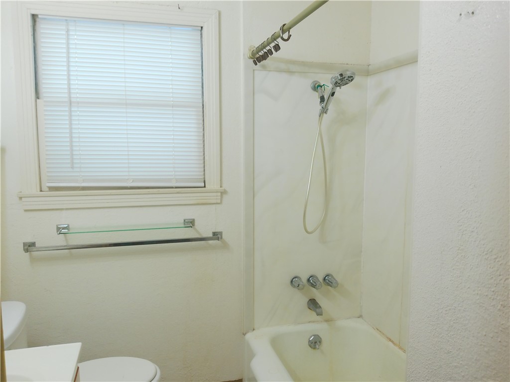 4322 Fir Street Corpus Christi, TX 78411 - Photo 7 of 17 a bathroom with a sink a toilet and shower