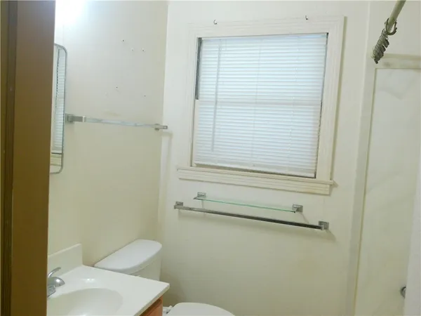 a bathroom with a toilet and a window