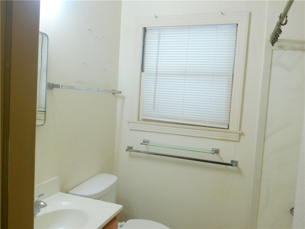 4322 Fir Street Corpus Christi, TX 78411 - Photo 8 of 17 a bathroom with a toilet and a window