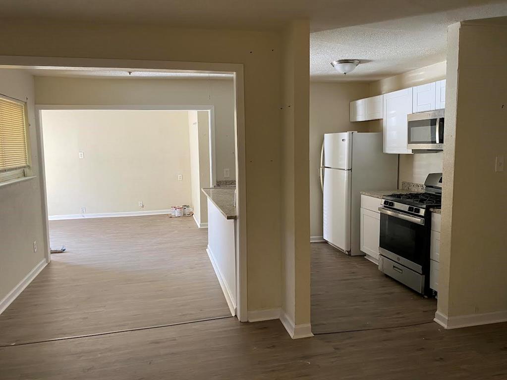 5105 Willie Street Fort Worth, TX 76105 - Photo 3 of 12 a kitchen with a refrigerator and a stove