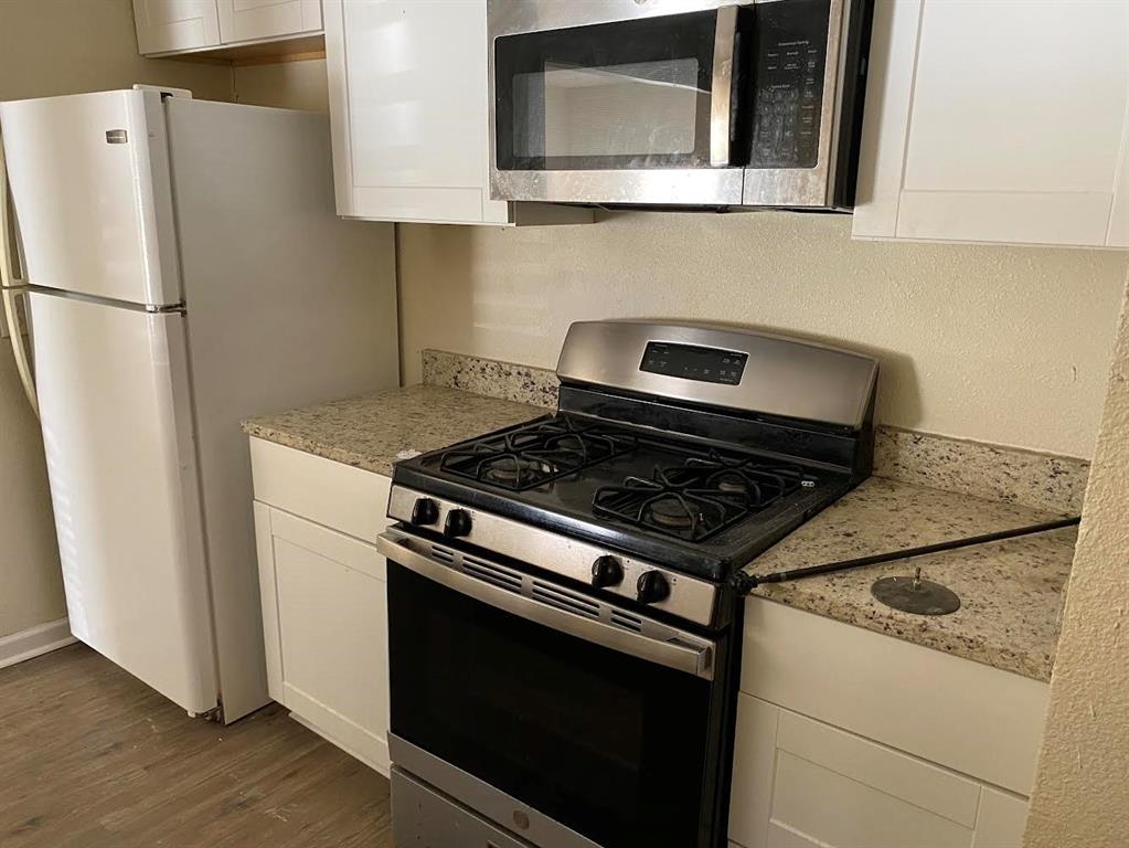 5105 Willie Street Fort Worth, TX 76105 - Photo 4 of 12 a stove top oven sitting inside of a kitchen