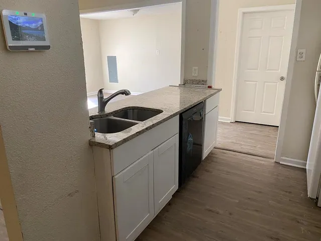 a kitchen with a sink and a refrigerator