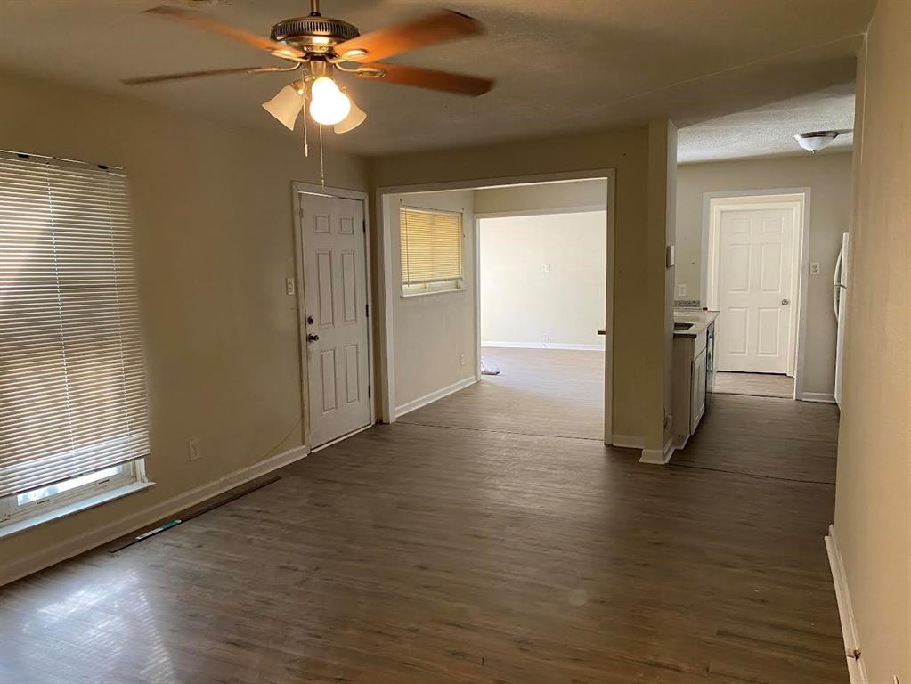 5105 Willie Street Fort Worth, TX 76105 - Photo 6 of 12 a view of empty room with wooden floor and fan