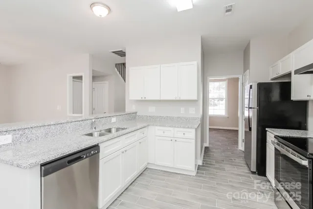 a kitchen with a sink stove and refrigerator