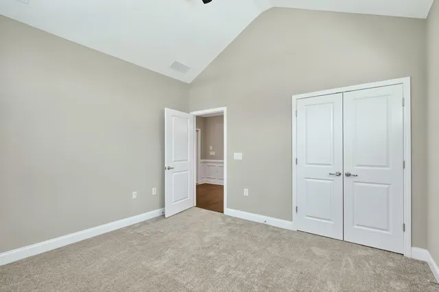 a view of an empty room and closet area