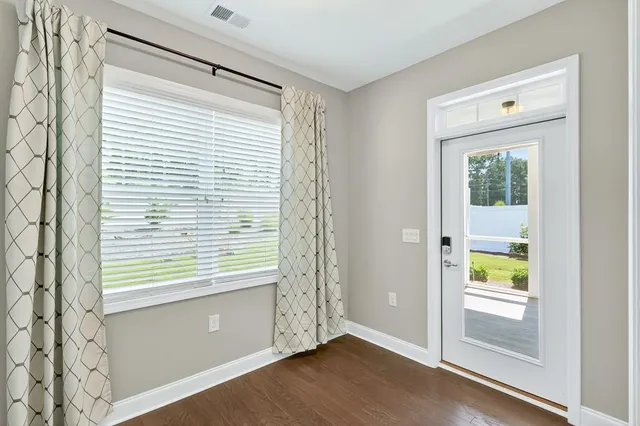 a view of an entryway with wooden floor