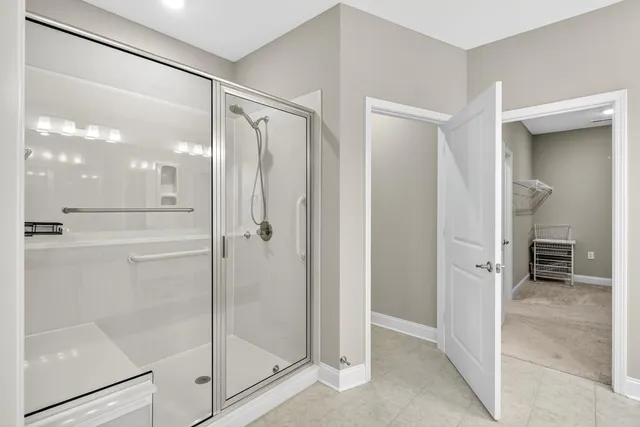 a bathroom with a glass shower door