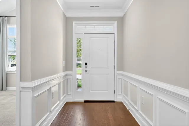 a view of an entryway with wooden floor
