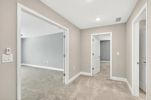 an empty room with closet and a bathroom