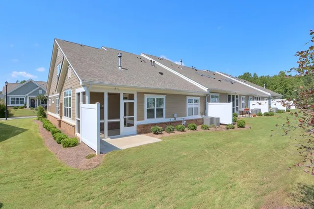 a front view of house with a garden and patio