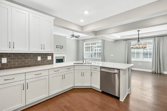 a kitchen with granite countertop white cabinets and white appliances
