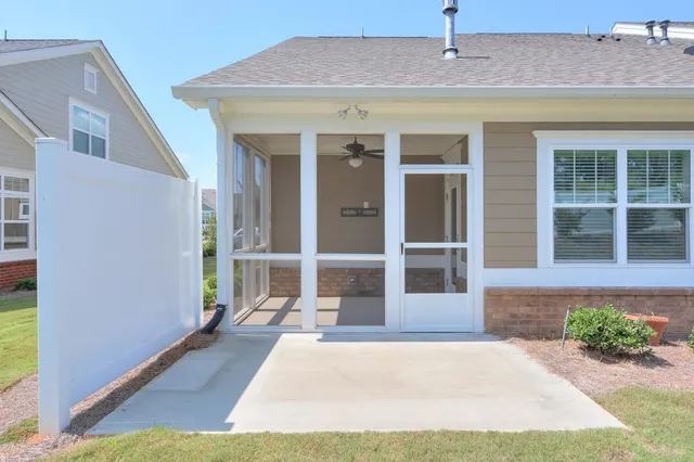 a front view of a house with a yard and potted plants