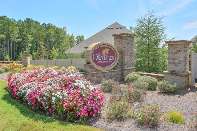 a street sign that is sitting in front of flowers
