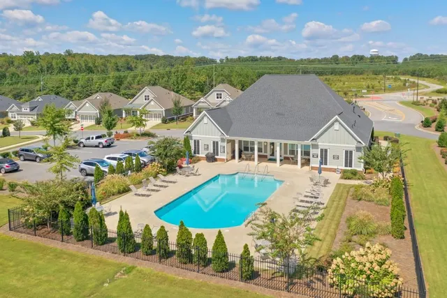 a view of house with outdoor space and swimming pool
