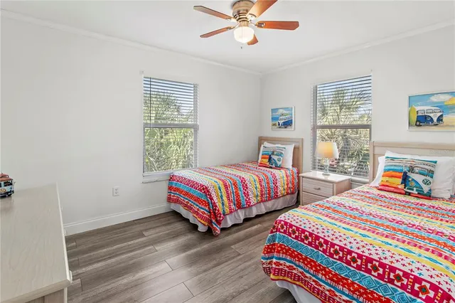 a living room with wooden floor and white walls