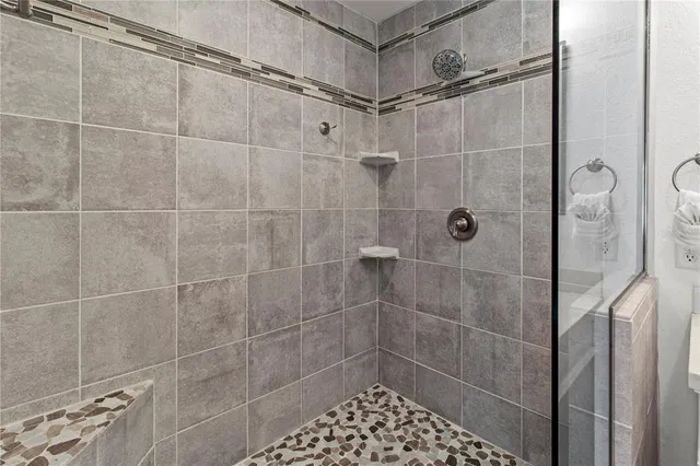 a bathroom with a double vanity sink mirror and shower