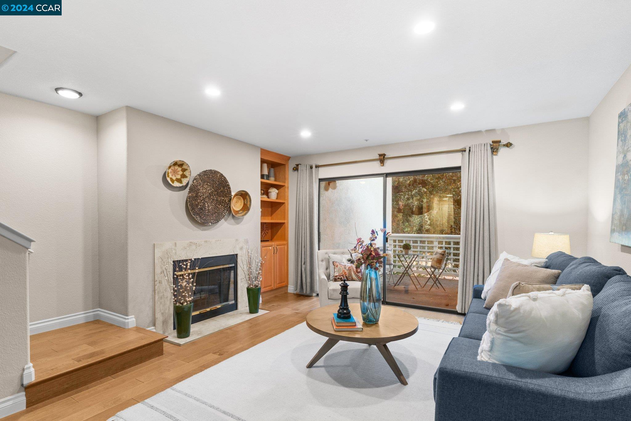 2586 Oak Road, Unit 230 Walnut Creek, CA 94597 - Photo 1 of 1 a living room with furniture a large window and a fireplace