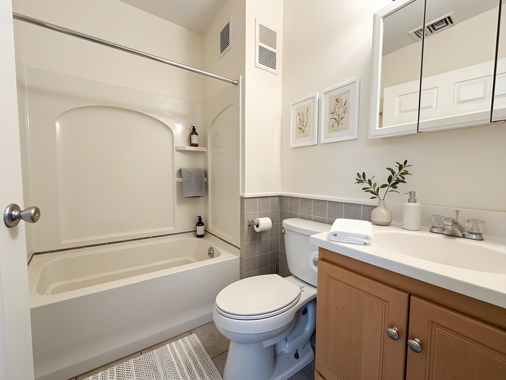 11 Vancouver Street, Unit 2 Boston, MA 02115 - Photo 3 of 14 a bathroom with a sink a toilet and a bathtub