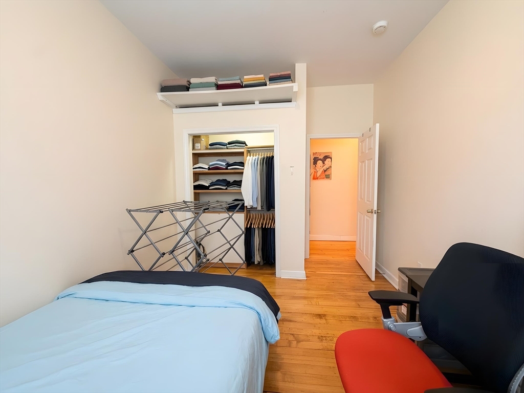 11 Vancouver Street, Unit 2 Boston, MA 02115 - Photo 7 of 14 a bedroom with a bed and furniture