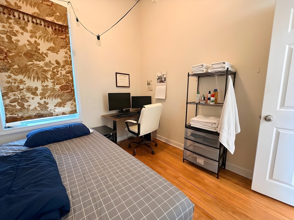 11 Vancouver Street, Unit 2 Boston, MA 02115 - Photo 9 of 14 a bedroom with a bed and a desk