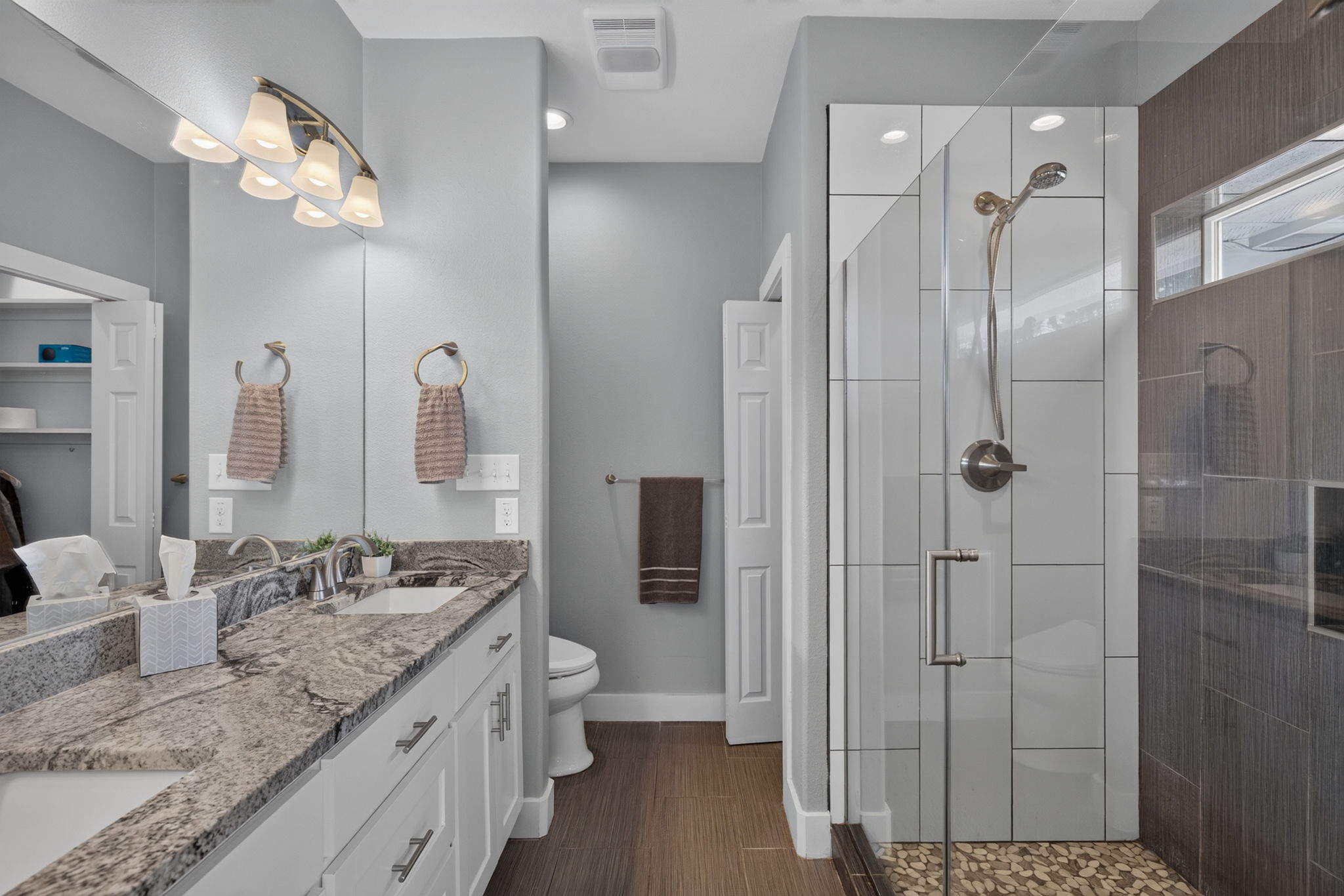 207 Deer Ridge Drive Burnet, TX 78611 - Photo 26 of 36 Dual vanity with ample counter space and a modern glass-enclosed shower create a serene bath retreat.
