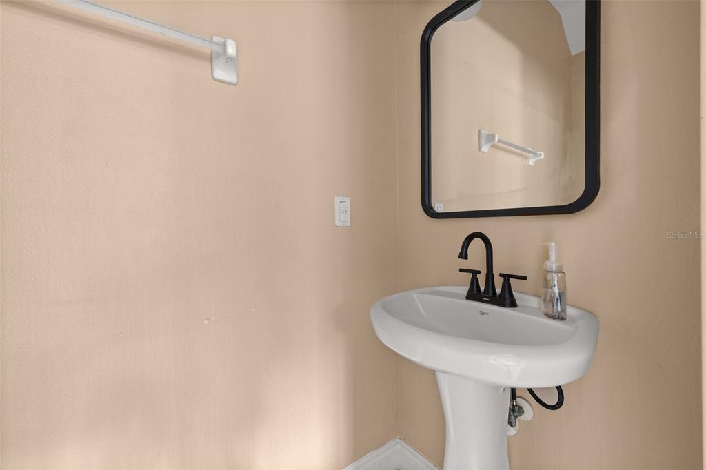 811 Assembly Court Reunion, FL 34747 - Photo 21 of 84 a bathroom with a sink and mirror