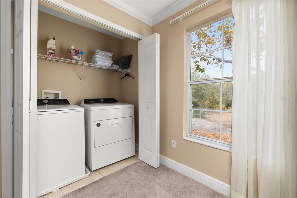 811 Assembly Court Reunion, FL 34747 - Photo 24 of 84 a utility room with cabinets washer and dryer